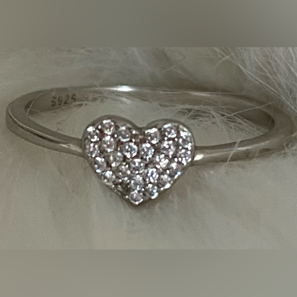 A dainty sterling silver Pavé heart ring .